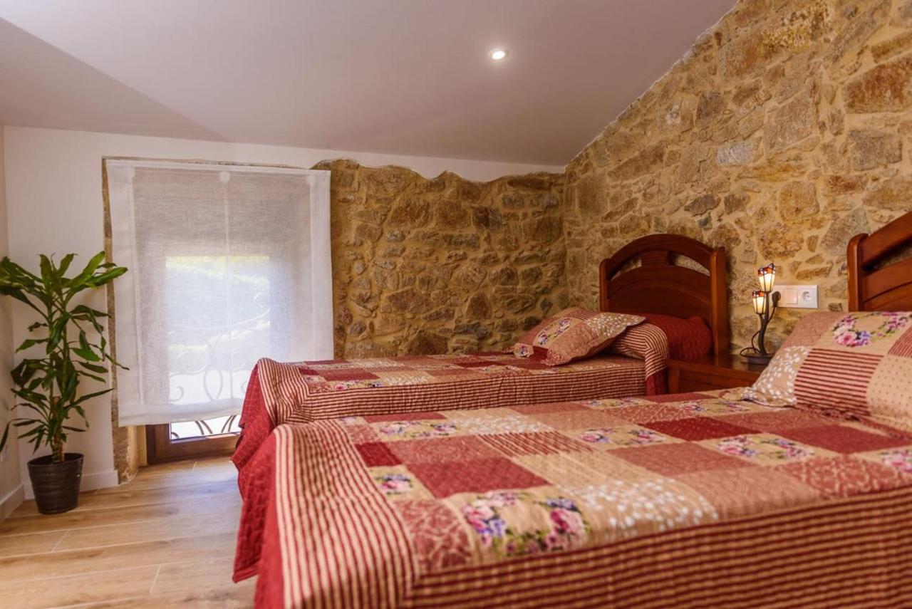 Segundo dormitorio con pared de piedra original y luz natural